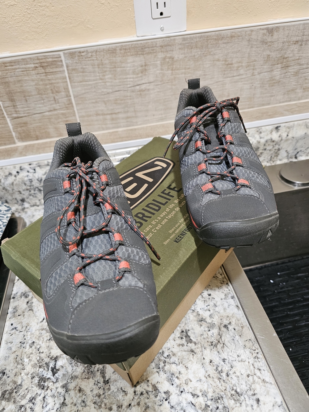 Keen dark gray trail shoes with coral accents